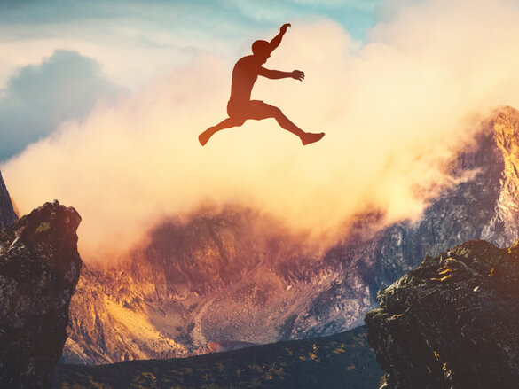 Man jumping between mountains at sunset. Concept of challenge, ambition, success. 3D illustration